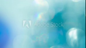 Optical Effects in Turquoise Tones. Loop. The light passes through the facets of a slowly rotating diamond and creates repetitive sparkling highlights and rainbow colors