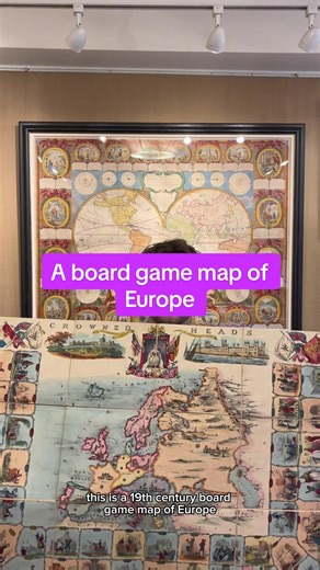 A 19th century educational board game with a map of Europe by David Ogilvy, titled: Crowned Heads or Contemporary Sovereigns: an Instructive Game. A 'roll and move' instructive game with a map of Europe with the countries numbered and 40 vignette historical scenes dated from 1688 to 1844-5. Above the map are a portrait of Queen Victoria on her throne, views of Windsor Castle and the Houses of Parliament, anf two trophies of national flags. Players need to identify the reigning monarchs and major