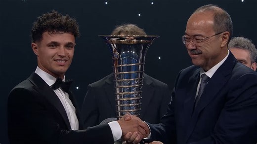 Norris lifts F1 trophy as unwell Verstappen skips FIA awards