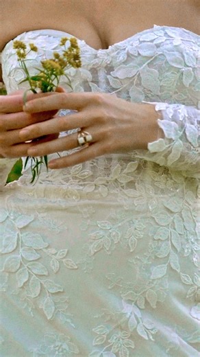 1.8K views | A fit and flare wedding dress with exposed boning will always be that girl. Style 66337 is exactly that. Complete with lace appliqué and tulle godets, it's the perfect look to stand out against any setting you could want to say "I do" in. | Lillian West | Facebook