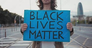 American student protest on the street for equal rights - Demonstrator holding hands carton poster with the slogan stop rasict police terror fight campaign
