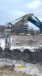 Kibag Group's Komatsu PC350 high reach working with an Egli crusher to demolish a basement wall in Zurich | RPA Media