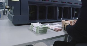 clip-1070257258-operating-electronic-machine-used-counting-money