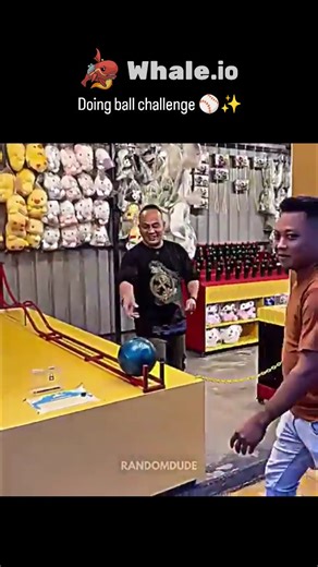 giggyvibe on Instagram: "The X post shares a 59-second video of the "Bowler Roller" carnival game, showing repeated failures where a bowling ball rolls back down a humped ramp, until one player succeeds by imparting backspin during release. Backspin increases surface friction and momentum transfer, allowing the ball to "crawl" over the hump—a physics-based trick documented in carnival analyses since at least 2019, despite game rules often prohibiting spins. With 4.9 million views and mixed repli