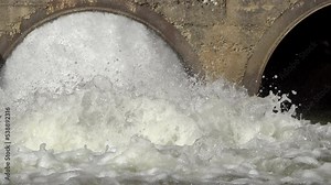 Closeup powerful fast bubbling water stream from a drain pipes of a hydroelectric power, dam. Slow motion Stock Video