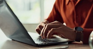 Laptop, typing and hands of person in home office with research, planning or creative writing on website. Remote work, computer and freelance writer with online article, report or copywriting at desk