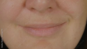 Female face, mouth and smiling lips close up. Face adult woman smiling by lips front camera. Expression people emotion concept