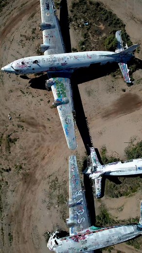 ✈️ Graffiti Graveyard in the Desert 🏜️ Hidden deep in the California desert, these abandoned airplanes have become massive canvases for graffiti artists. Once symbols of flight—now grounded in silence and decay. This aerial view captures a surreal piece of forgotten history. #AbandonedPlanes #CaliforniaDesert #UrbanExploration #Route66 #AviationGraveyard #GraffitiArt #DesertDiscoveries #AbandonedPlaces #DroneView #ForgottenAmerica #OffTheBeatenPath | The Abandoned Project