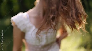 girl in white dress dancing in the forest and playing hair