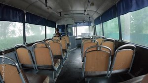 Old vintage bus from inside while driving. Driving Empty Bus. An old design bus with seats and large windows driving on day. Old Soviet bus inside