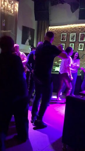 Energetic Group Dance at a Lively Bar Setting
