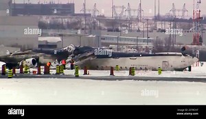 This image taken from video provided by CTV shows workers near the crashed passenger jet on a tarmac of the Toronto Pearson Airport on Wednesday, Feb.19, 2025. (CTV via AP Stock Photo - Alamy