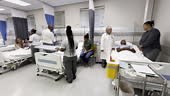 Full and busy hospital ward in South Africa. There are children,...