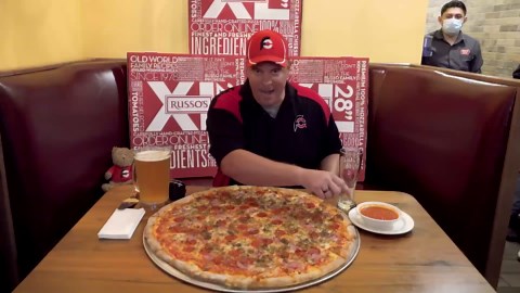Man attempts impossible 28-inch pizza challenge with full pitcher