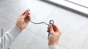 Bowline knot. Process of tying Bowline process is a top view on the gray background