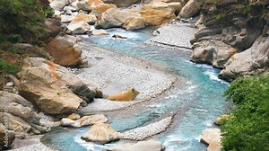 Strong stream in deep valley.gurgling pour water.Charming Valley,textured rock form a spectacular scenic scene view. Yanzikou, Taroko National Scenic Area,Hualien County,Taiwan. Pan camera work.