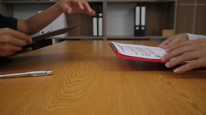 Download Businessman signing a paper contract in a business deal for free