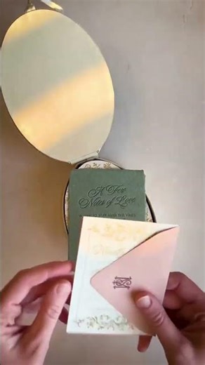 An oval box invitation suite designed to feel immersive and a little magical