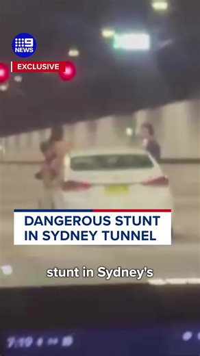 The dangerous stunt saw two people climbing out of the car's windows, before a third joined in. #9News | 9 News Sydney
