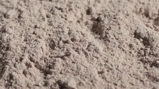 Fine, powdery flour with a textured surface, appearing soft and loosely packed | Premium Stock Video Footage
