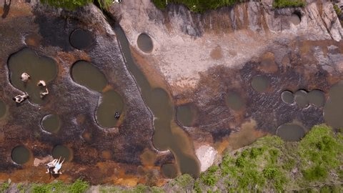 clip-4030374839-overview-multiple-natural-pools-flowing-river-people
