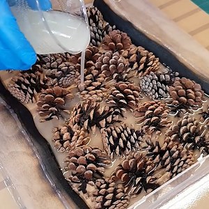906K views · 10K reactions | Pinecone Infused Epoxy Resin Clock A Rustic Woodworking Masterpiece | DIY & Crafts USA | Facebook