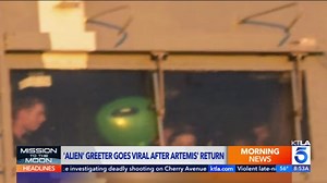 Green alien greets Artemis II astronauts