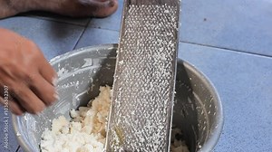 grate the coconut manually using a coconut grater.