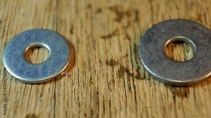 Metal washers of different sizes remain on the surface, very close-up