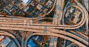 Transport on the highways of a huge interchange. Famous freeway interchange in Los Angeles, California, United States. Aerial view of traffic in Interstate 110 and 10 Highway full of cars and trucks.