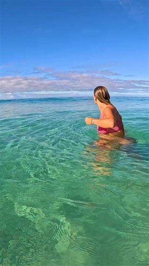 big pregnant woman plays in the breaking waves. is this safe for pregnant or should she be inside doing nothing?