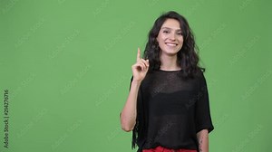 Young beautiful woman pointing up