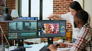 Diverse mixed race couple working as a team for a freelance video shoot, editing and mixing video clips in post production using modern software. Multiethnic people do remote work. Camera A.