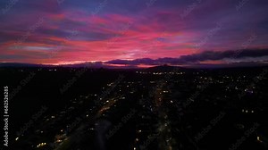 Paignton, Torbay, South Devon, England: DRONE VIEWS: A deep red sunset illuminates the skyline. Paignton is a popular UK holiday resort and destination with many tourist attractions (Clip 2).