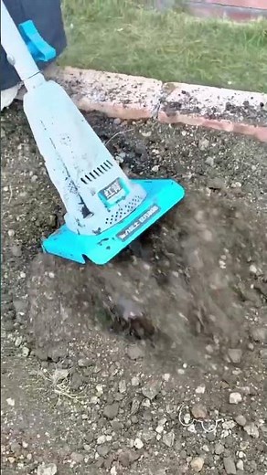 Using an electric garden tiller to loosen and prepare the soil for planting