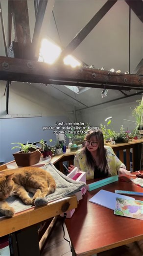 Who agrees? 🙋🏻‍♀️ Here I’m binding some coloring books while Cheddar naps nearby 🐈💕 get your hands on a hard or digital copy of my coloring book @Intention Boutique #witchyaesthetic #witchyartist #bookbindingathome