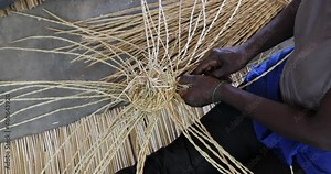 African Woman making a grass basket traditional village Ghana. Northern Ghana art craft village specializing in pottery, baskets, leather and painting. Income producer for tourism and export world.
