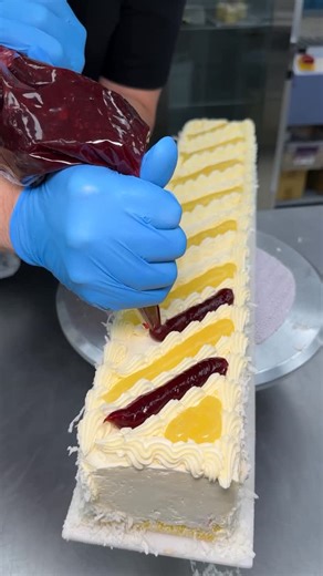 Freed's Bakery on Instagram: "Have you tried our Lemon Breeze Cake Slice? 🍋 It’s a light lemon cake filled with our signature Bavarian cream, raspberry preserve, and iced with true European buttercream. Topped with lemon creme and raspberry puree with coconut shavings on the sides 🥥 Come see why people have loved FREEDS since 1959!!! 🌟 9815 S Eastern Ave (Freed’s Bakery) 🍰 10870 W Charleston Blvd (Summerlin) 🧁 6475 N Decatur Blvd (Centennial Hills) 🎂 60 E California Ave (Downtown) 🍦8730 W