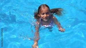 Little girl swimming in the pool