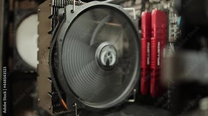 Rotation of coolers for cooling in the computer system unit. Cleaning your computer from dust, close-up