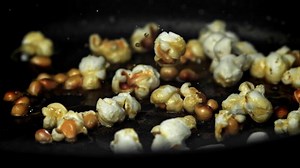 Popcorn explodes in the pan. Filmed on a high-speed camera at 1000 fps. High quality FullHD footage