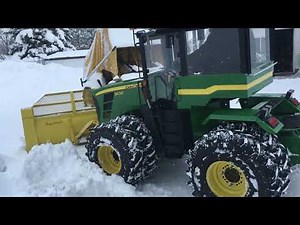 Mini John Deere 9630 Articulating tractor plowing deep snow.