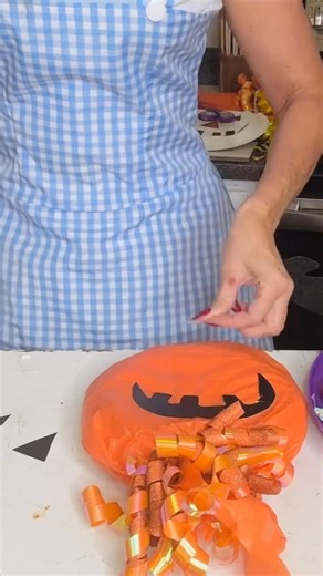 Here’s a fun DIY Dollar Tree candy pumpkin your kids and grandkids will love — just fill two party plates with candy, wrap in tissue paper, and add eyes for a sweet fall surprise! 🎃🍬👀 | Olivia's Romantic Home DIY