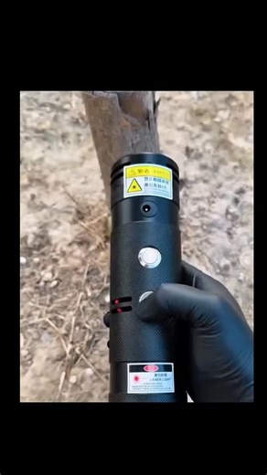 Evolve with Tech on Instagram: "The post showcases a 16-second video of a gloved hand using a handheld fiber laser cutter to melt and slice through a steel rod embedded in a wooden stump, emphasizing its alarming power with over 1 million views and 2,600 likes. This device, likely a 50-100W portable model from brands like xTool or generic Chinese manufacturers, enables metal cutting in seconds but poses serious risks, including instant blindness or burns without proper eyewear and gloves, as war