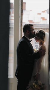 silhouette of the bride and groom in the room near the window.