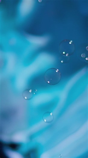 Bubbles and a dynamic blue background in an abstract composition - Free Stock Video