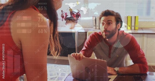 Man using laptop while woman leaning, pointing documents and starting business graphs over laptop