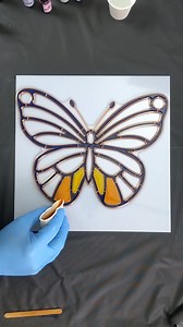 Bright and colorful faux stained glass butterfly. The thick borders can be colored with opaque or transparent colors making this template really versatile. #resinarttemplate #mixedmediaart #resinartwork #artcreation #stainedglass | Pour Away Fluid Arts