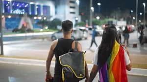 Gay couple have fun festival go city street. Happy people crowd hang out queer community month party. Bi men walk lgbt pride fest. Lgbtq coming out. Colorful rainbow flag symbol. Joy parade march.