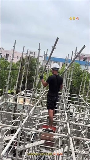Very Skillful Worker Installing Scaffolding Tubes by hand